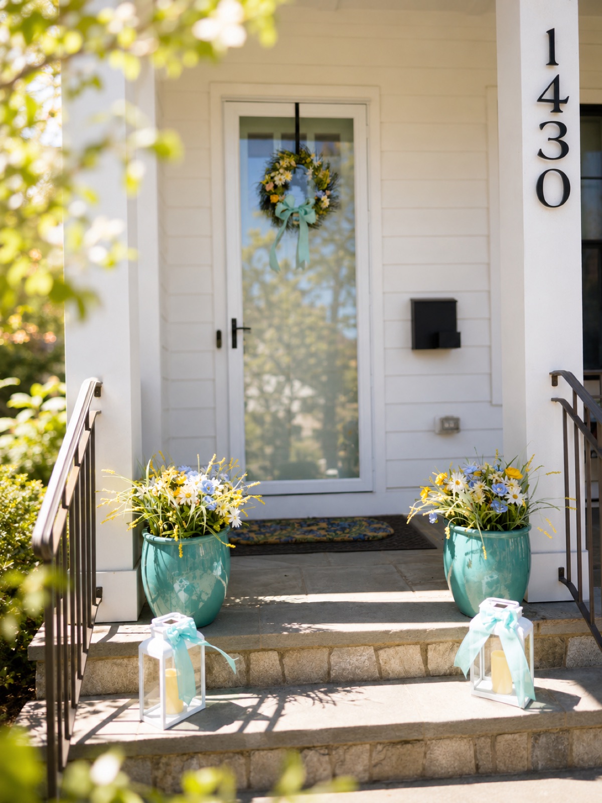 A white front door with a wreath and planters on the steps, McLean, Virginia